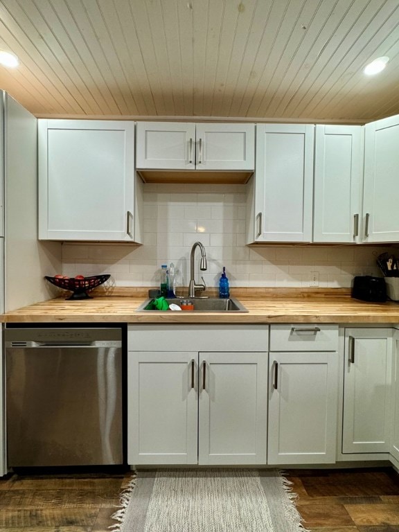 kitchen with stainless steel dishwasher, butcher block counters, sink, and white cabinets