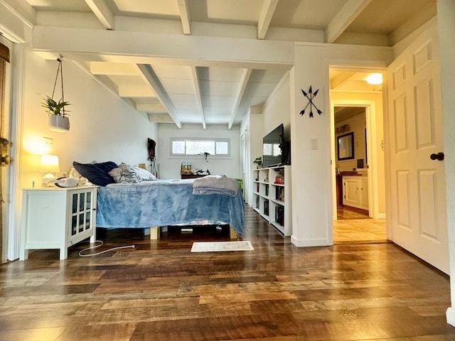 bedroom with beamed ceiling and dark hardwood / wood-style flooring