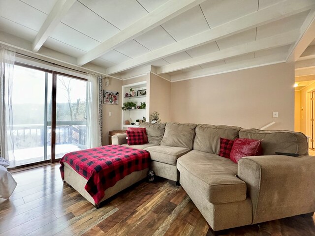 living room with beam ceiling and dark hardwood / wood-style flooring