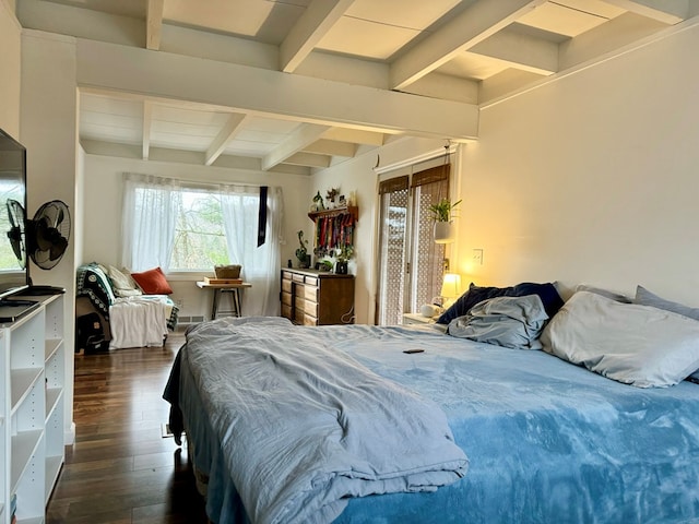 bedroom with beamed ceiling and dark hardwood / wood-style floors