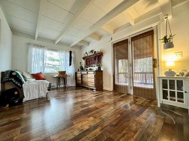 living area with dark hardwood / wood-style floors and vaulted ceiling with beams