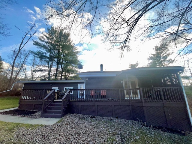 rear view of house featuring a wooden deck