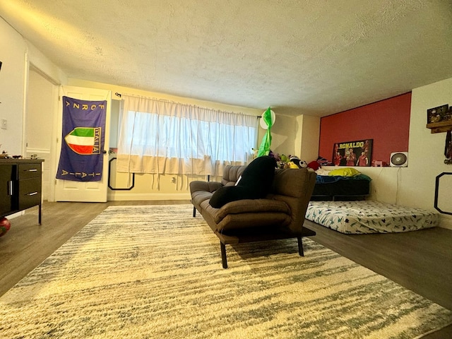 interior space featuring hardwood / wood-style flooring and a textured ceiling