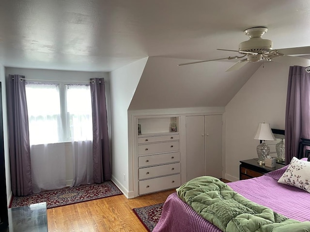 bedroom featuring vaulted ceiling, a closet, ceiling fan, and light hardwood / wood-style flooring