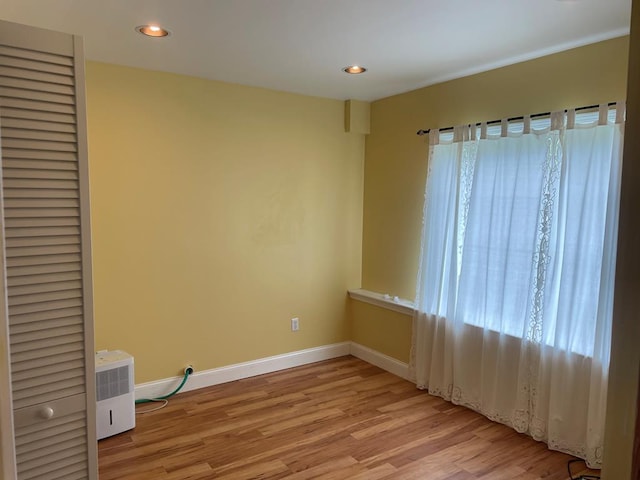 spare room featuring light hardwood / wood-style floors