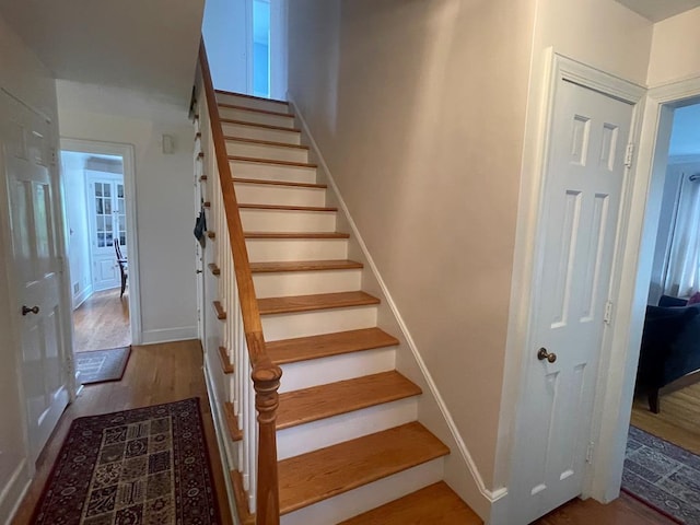 staircase with wood-type flooring