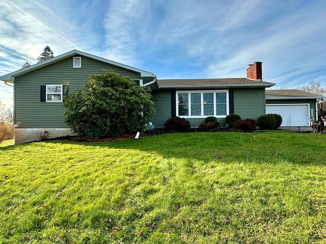 single story home with a garage and a front lawn