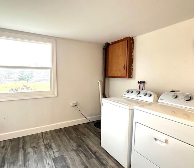 washroom with cabinets, dark hardwood / wood-style flooring, and washer and clothes dryer