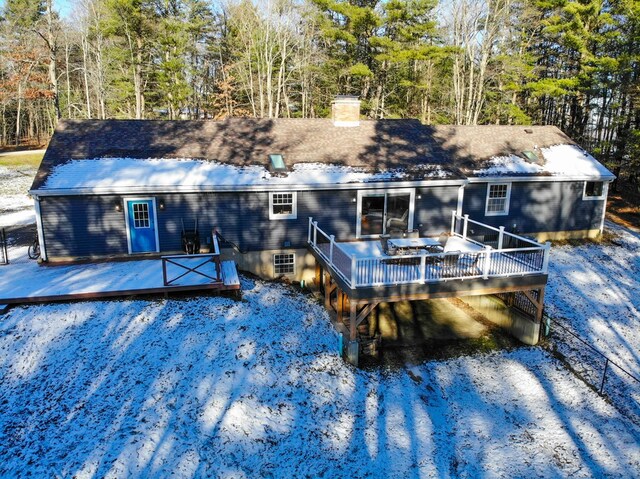 rear view of property with a wooden deck