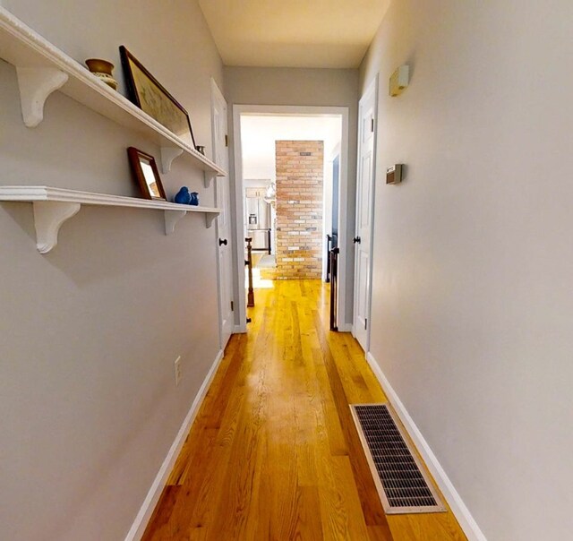 hallway with light hardwood / wood-style flooring