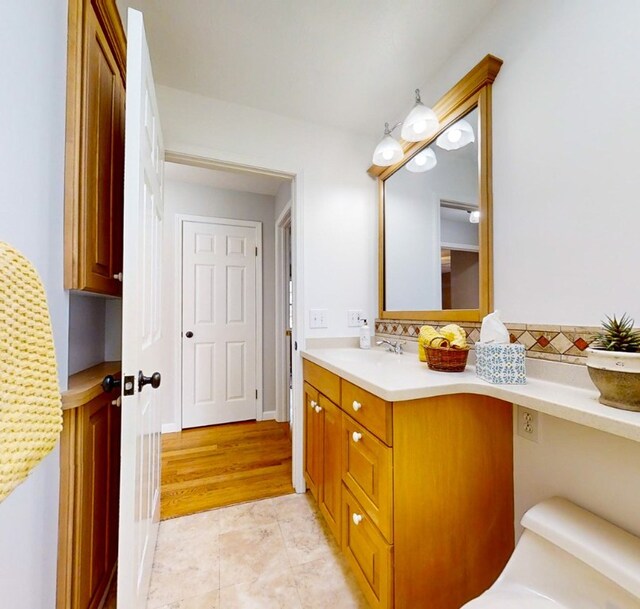 bathroom featuring vanity and toilet