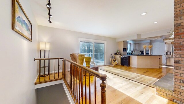 interior space featuring track lighting and light hardwood / wood-style floors