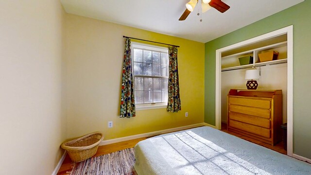 bedroom featuring hardwood / wood-style flooring, a closet, and ceiling fan