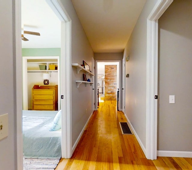 hall with hardwood / wood-style floors