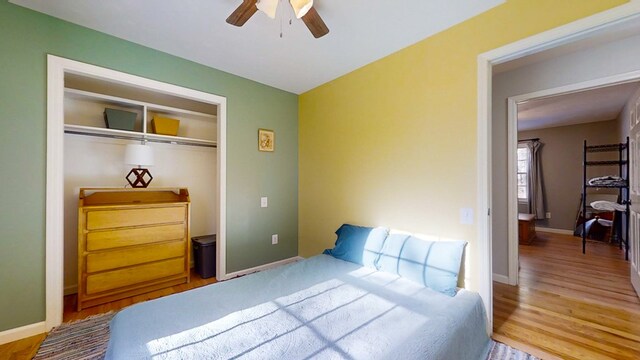 bedroom with hardwood / wood-style flooring, a closet, and ceiling fan