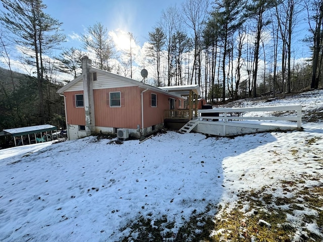 view of snow covered exterior featuring a deck