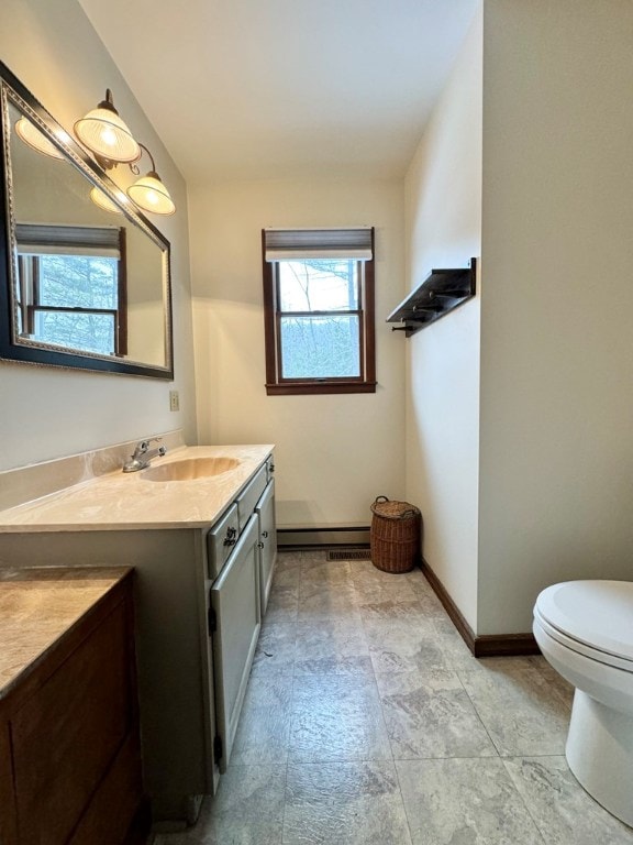 bathroom featuring vanity, a baseboard heating unit, lofted ceiling, and toilet