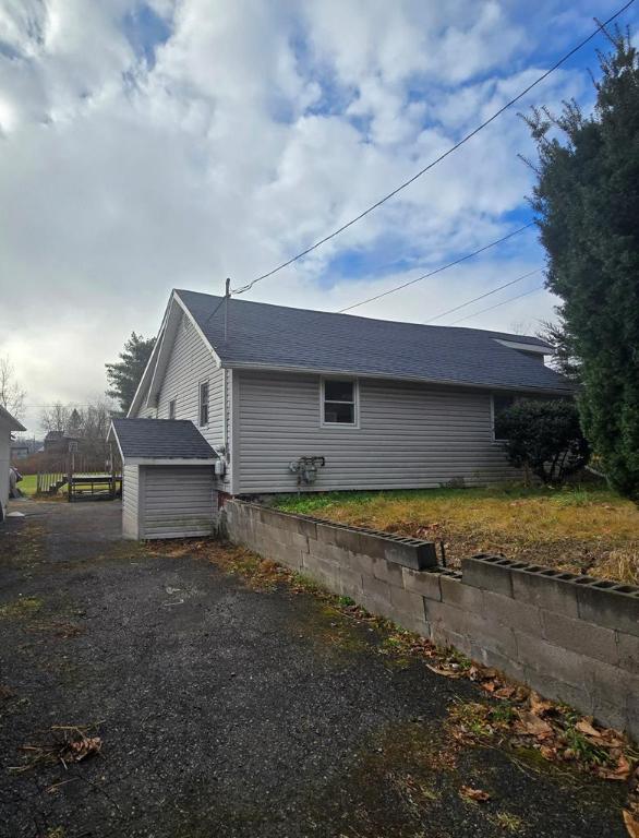 view of property exterior with a storage shed