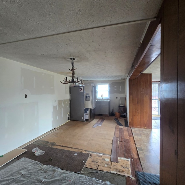 interior space with a chandelier and a textured ceiling