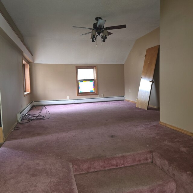 unfurnished room with ceiling fan, carpet floors, vaulted ceiling, and a baseboard heating unit