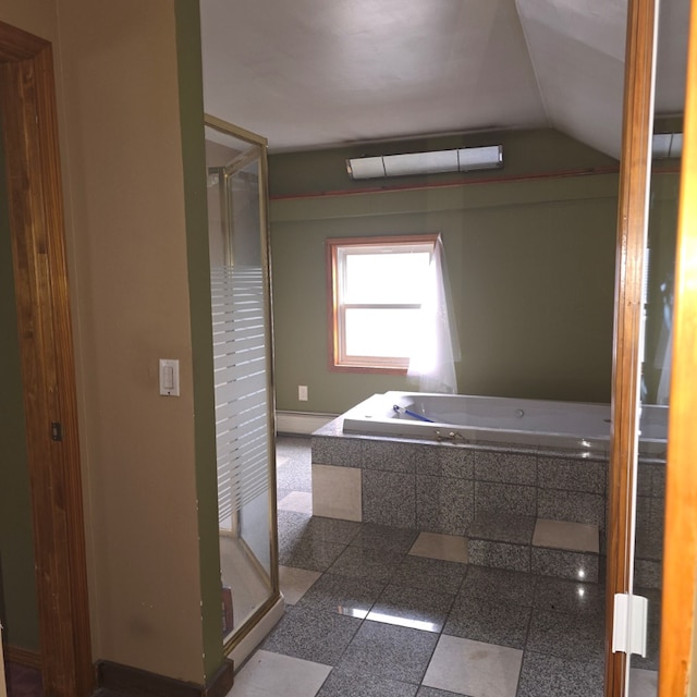 bathroom featuring lofted ceiling, a baseboard heating unit, and a tub