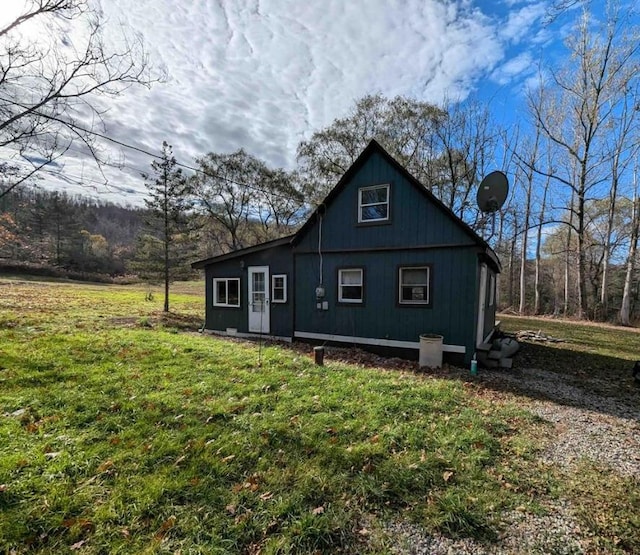 back of property featuring a lawn