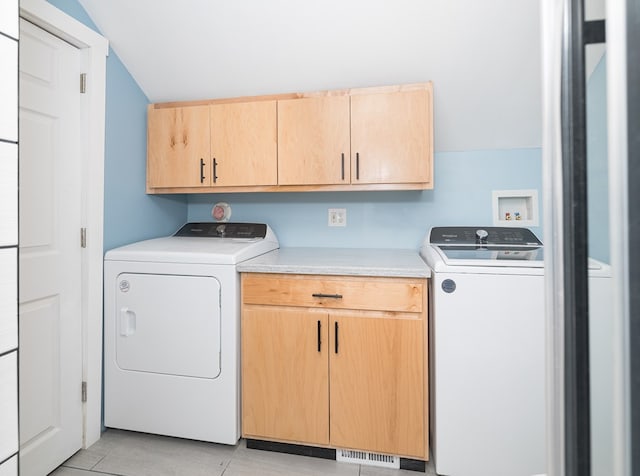 laundry room featuring cabinets and washer and clothes dryer