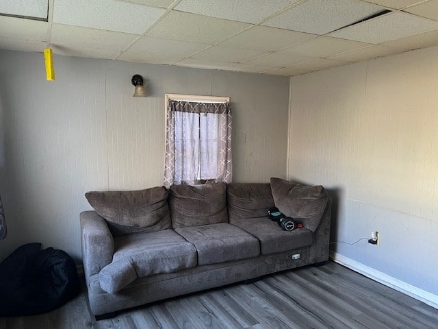 living room with hardwood / wood-style flooring and a paneled ceiling