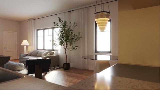 living room featuring hardwood / wood-style flooring, a healthy amount of sunlight, and a chandelier