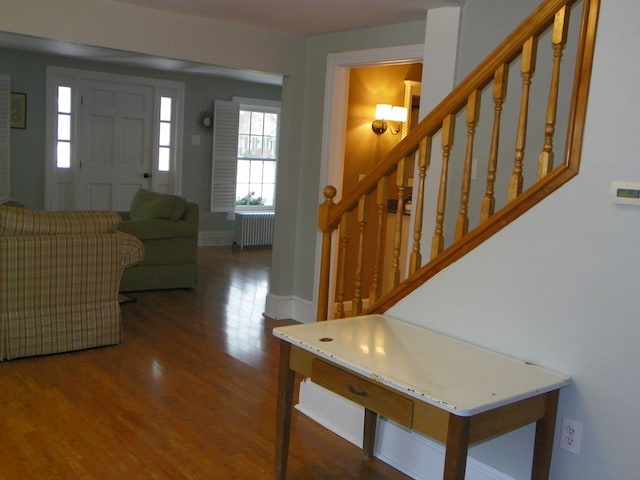 entrance foyer featuring radiator heating unit and dark hardwood / wood-style floors