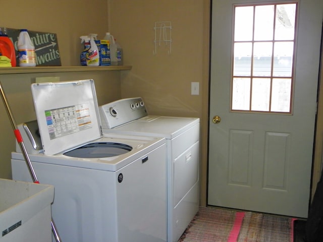 clothes washing area featuring washer and dryer