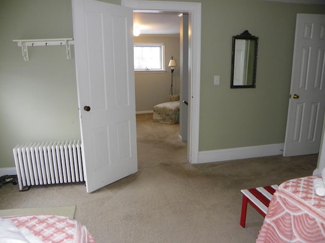 bedroom featuring radiator and carpet