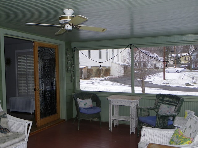 sunroom / solarium featuring ceiling fan and radiator