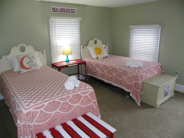 bedroom featuring multiple windows and dark colored carpet