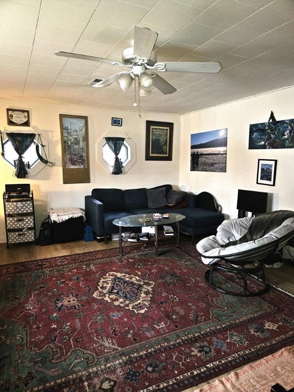 living room with hardwood / wood-style flooring and ceiling fan