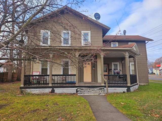 view of front of home featuring a front yard and covered porch