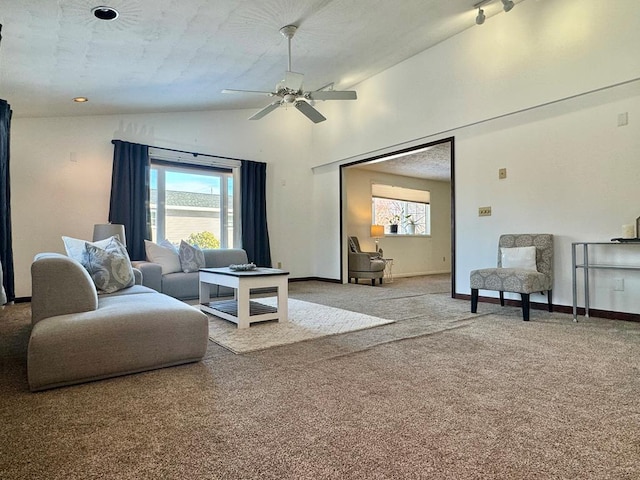 carpeted living room featuring ceiling fan and high vaulted ceiling