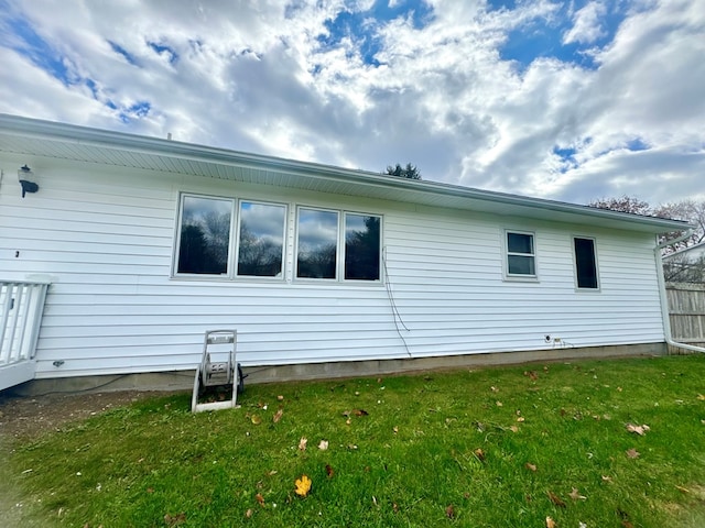 view of property exterior with a lawn