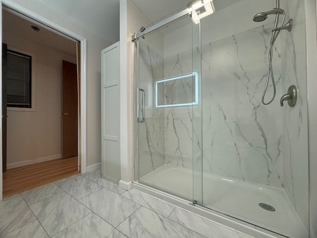 bathroom with a shower with shower door