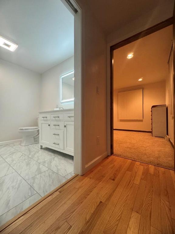 hallway featuring sink and light hardwood / wood-style floors