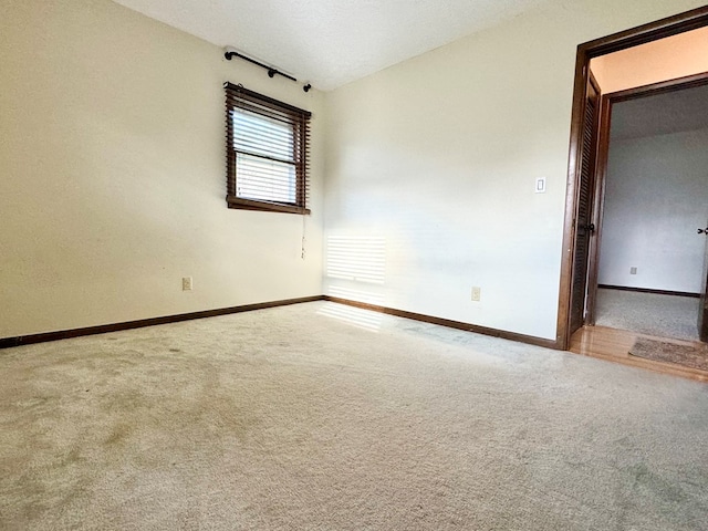 unfurnished room with vaulted ceiling and carpet