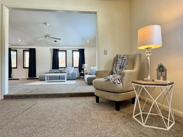 sitting room with carpet floors, vaulted ceiling, ceiling fan, and plenty of natural light