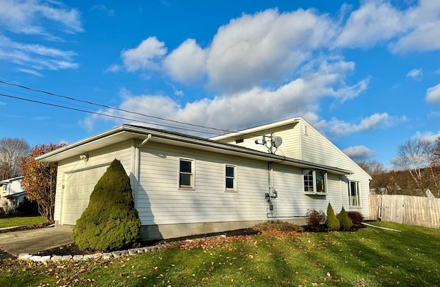 view of side of property with a garage and a yard