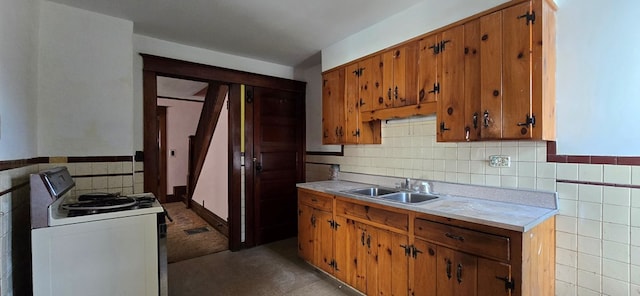 kitchen with tile walls, sink, and white range with electric stovetop