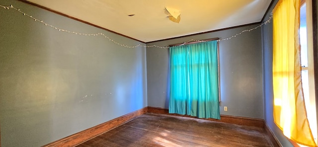 spare room with wood-type flooring and ornamental molding