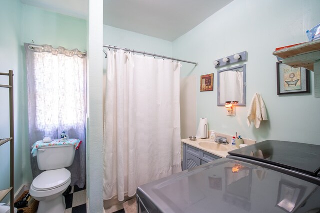 bathroom featuring vanity, toilet, and curtained shower