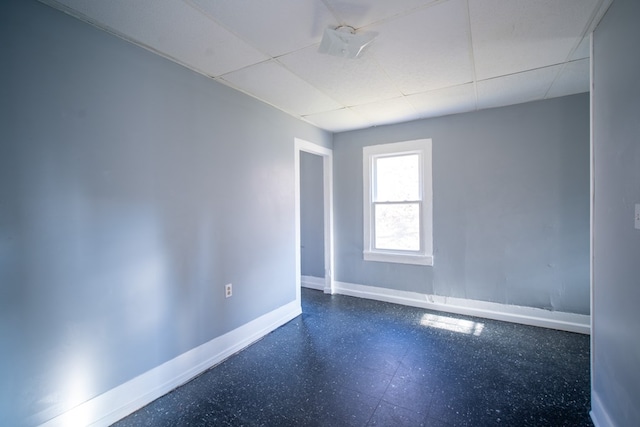 unfurnished room featuring a paneled ceiling