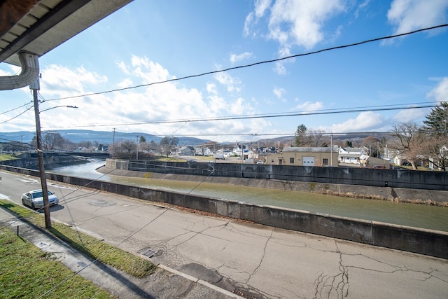 exterior space featuring a water and mountain view