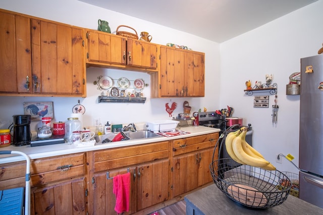 kitchen featuring sink and stainless steel refrigerator