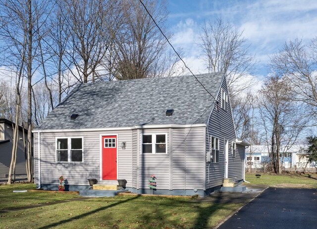 cape cod home with a front yard